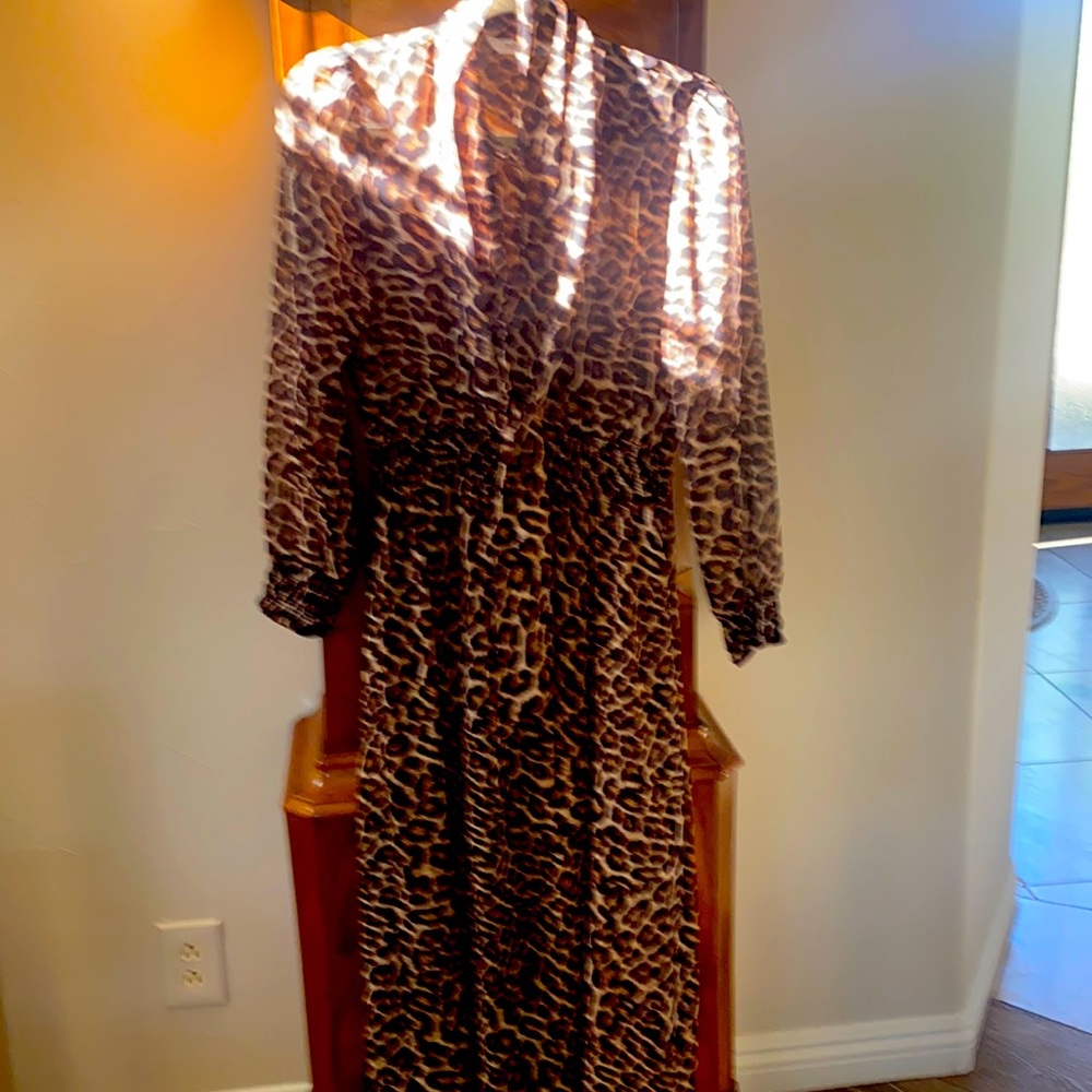 This is a darling animal print dress- midi, with a loose tie at neck.